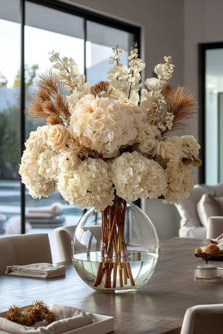 A picture of a beautiful mixed flower floral arrangement in a white ceramic vase, Third & Main