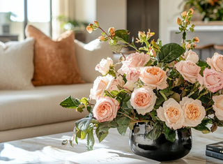 Beautiful faux flowers on a table in a bright room.