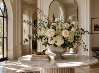 Elegant marble table with a large lush floral arrangement 