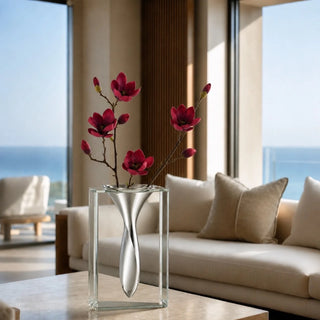 13 inch clear crystal vase with sculptural polished aluminum insert styled with tulips on a console, showing the faceted crystal body and reflective metal form; florals not included.