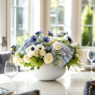Elegant blue and white faux floral centerpiece with real touch blue anemones, roses, and hydrangeas in a white bowl vase on a formal dining table by Third & Main
