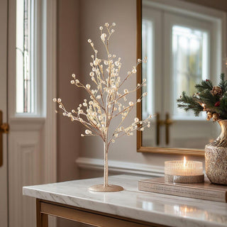18-inch gold glittered twig tree with pearl accents displayed on marble console beside candle and greenery – elegant tabletop holiday décor for entryway or living room.