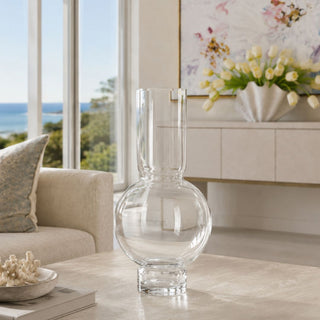 19.75 inch Tall Monceau Clear Glass Vase styled on luxury coastal coffee table with ocean view and soft neutral designer decor