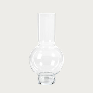 Sculptural clear glass vase with globe base and elongated neck. The 19.75" Tall Monceau Vase adds refined luxury to consoles, dining tables, and statement arrangements.