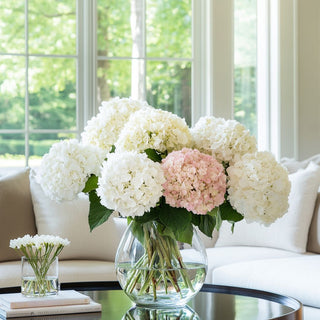 20" True Bloom Floral real touch Light Pink faux  hydrangea stem from True Bloom Floral by Third & Main is styled in a glass vase with cream and white hydrangea stems, ultra-realistic artificial bloom with full layered petals and green leaves, high-end home decor stem, True Bloom Floral decorated in vase sitting on a table in a stylish contemporary decor style living room