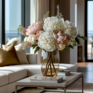 true bloom real touch white peony stem styled in a beautiful arrangement with other spring complementary spring florals in a glass vase in a coffee table of a luxury home decor styled living room. 