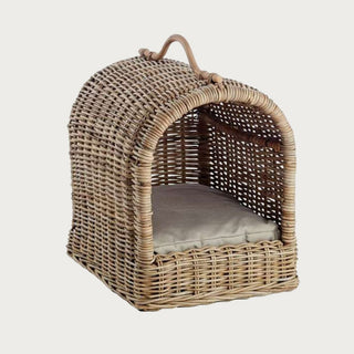 Handwoven rattan pet bed with arched top and cushion in brown-gray
