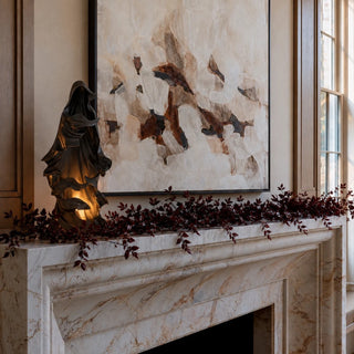 Styled 24.25 inch black draped LED ghost in matte resin with layered hooded folds, warm amber interior glow, and built-in timer for entry, mantel, and Halloween decor.