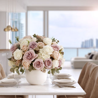 Elegant faux floral arrangement with real touch dusty pink roses, white hydrangeas, and blush blooms in a white ceramic vase on a modern dining table by Third & Main