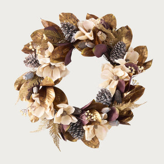 Close-up of magnolia wreath featuring gold leaf, pinecones, and neutral blooms – 26-inch decorative holiday wreath with metallic accents for front door or indoor display.