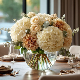 27.5 styled light cream faux hydrangea stem in a round glass vase with other fall inspired florals on the table in a luxury decor style dining room 