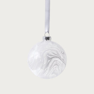 3.25-inch white marbled glass ornament with satin ribbon displayed on Christmas tree in neutral living room – sophisticated winter-white Christmas ornament.