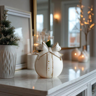 Small matte white porcelain LED tabletop ornament with built-in timer displayed in cozy living room – warm, elegant holiday lighting accent for mantels or side tables.