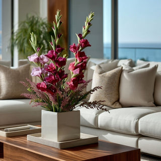 35 Inch Fuchsia True Bloom real touch gladiolus stems arranged in a modern white square vase on a wood coffee table in a refined neutral living room