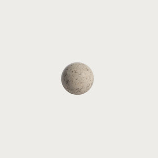 Medium 4-inch natural travertine stone decorative orb with cream and beige mineral variation for bowls, trays, shelves, and tabletop styling.