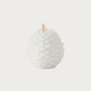 4.5-inch Luminara snowy white flameless candle with glittered pinecone design for winter and holiday decor.