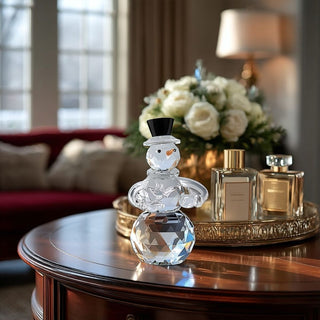 Crystal snowman figurine on a table with perfume bottles in a living room setting