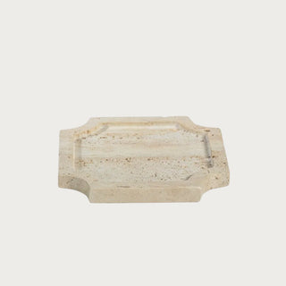6.75 inch creamy travertine stone decorative tray with a carved square profile, softly notched corners and natural porous stone variation.