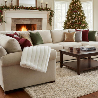 60" Army white faux fur throw blanket draped across a luxury sofa in a modern farmhouse decor style living room with a Christmas tree in the background. Perfect for winter, a christmas present, or holidays. 