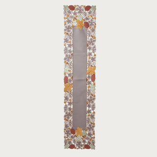 68 inch embroidered cutout fall leaves table runner with a taupe center and dimensional rust, ochre, sage and brown leaf border for autumn table decor.