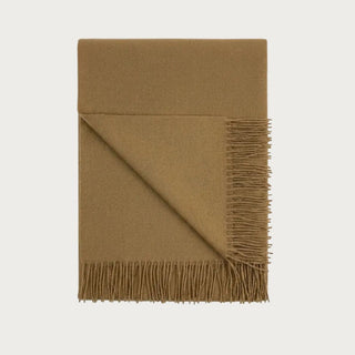 Folded 70-inch Honey throw blanket woven from 100% baby alpaca with a warm camel-gold color and tonal fringe.
