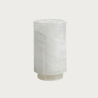 8.25-inch polished alabaster vessel with creamy white natural stone variation and cylindrical shape for use as a vase, beverage holder, or candle holder.