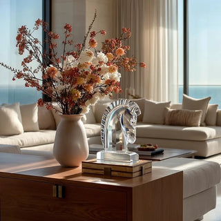 9.25 inch clear crystal horse head sculpture styled on a warm wood console beside an early fall floral arrangement in a sunlit modern contemporary Malibu living room.