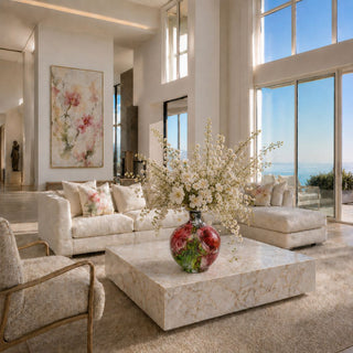 Amaryllis Artist hand-painted porcelain vase styled with white floral arrangement on luxury coffee table in grand coastal living room with ocean view