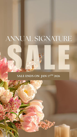 A beautiful spring bouquet of pink florals, tulips, roses and greenery placed in a modern light brown vase, contemporary modern luxe home decor, set in a warm toned modern luxe home