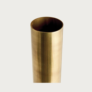 Close-up of a tall iron vase showing its narrow cylindrical opening and softly brushed antiqued brass finish.