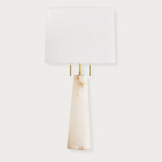 Modern alabaster table lamp with tapered conical base, brass hardware, and rectangular pull chains topped with a white lampshade. Home Decor, Third & Main, alabaster table lamp, modern table lamp, alabaster stone lighting, brass table lamp, bedside lighting, contemporary lamp, Luxury decor