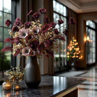 Beautiful styled photo of a luxury modern contemporary decor style home with the burgundy  flower stem and other complementary florals in a vase on a console table 