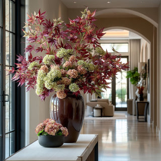 Beautifully styled on an entryway table the japanese maple stem with complementary florals 