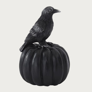 Side view of the 8.25 Inch Black Resin Evermore Crow & Pumpkin showing the perched crow, silver-highlighted feather texture, ribbed pumpkin base, and dark seasonal design.