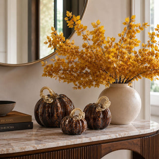 Brown Speckled Handblown Glass Pumpkins in large, medium, and small sizes styled on a marble console with golden fall foliage and warm neutral decor.