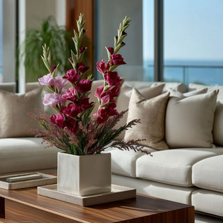Burgundy True Bloom real touch gladiolus arranged in a white square vase on a wood coffee table in an elevated neutral living room