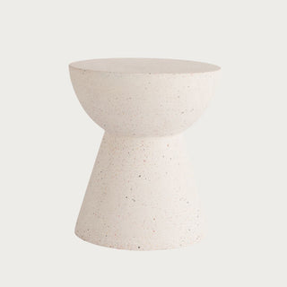 Terrazzo-style stone pedestal side table with sculptural hourglass silhouette in warm ivory tone