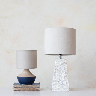 modern farmhouse style lamp on table beside navy ceramic lamp