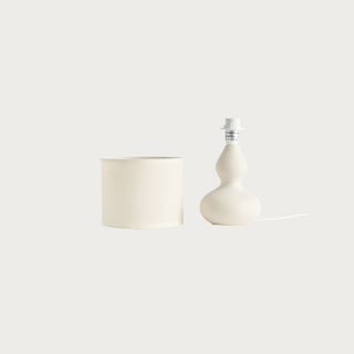 An off-white ceramic table mini gracie lamp with a distinctive double-bulb gourd shape and a matching cylindrical fabric shade, shown against a solid off-white background.