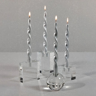 Clear round crystal taper candleholder styled with metallic silver twist candles for a winter home decor look. 