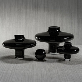 Collection of handmade black glass vases in varying sizes displayed on gray surface – contemporary decorative glassware set for modern interiors.