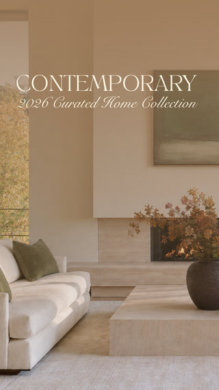 A styled interior scene showing a modern living room with a cream sofa, matching armchair, low rectangular coffee table, large dark vase with autumnal branches, and tall windows overlooking a wooded landscape. Large overlaid text reads 'CONTEMPORARY 2026 Curated Home Collection.