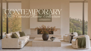 A styled interior scene showing a modern living room with a cream sofa, matching armchair, low rectangular coffee table, large dark vase with autumnal branches, and tall windows overlooking a wooded landscape. Large overlaid text reads 'CONTEMPORARY 2026 Curated Home Collection.