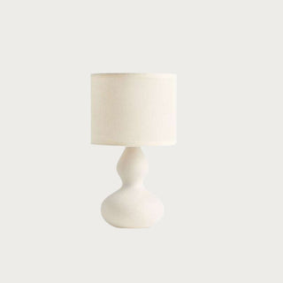 10.5-inch Gracie mini table lamp with a warm white sculpted double-gourd ceramic base and coordinating cream linen drum shade.