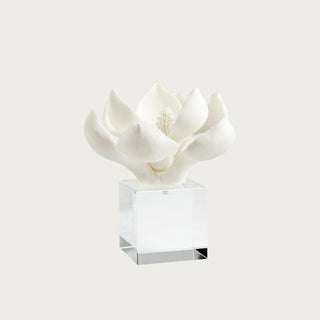 Close view of sculptural white magnolia bloom with layered petals resting on solid crystal base, modern transitional home decor accent from Third & Main