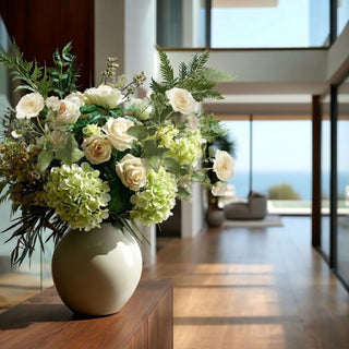 20 inch Cream True Bloom real touch Distant Drums rose spray with layered cream blooms, subtle center detail, and natural green foliage, styled in an arrangement in a modern contemporary decor style home.