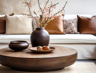 A decorated  Living Room in Neutral and Brown colors with a floral arrangement on the coffee table, Third & Main home Decor Shop