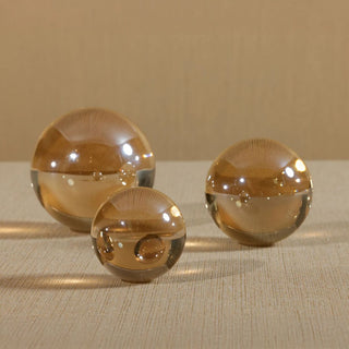 Amber crystal glass decorative balls in three sizes, elegant accent decor for coffee tables, consoles, or shelving displays. Third & Main, Home Decor, Decorative Orb, Holiday Decor, Winter Decor, Everyday Decor, Seasonal Decor, Luxury Decor, Contemporary Decor