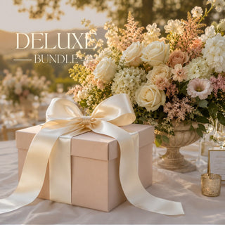 Deluxe Surprise Bundle Box sitting on top of a luxury linen table, surrounded by fresh florals, candles and dishware. Table is outside in a sunny california outdoor party.