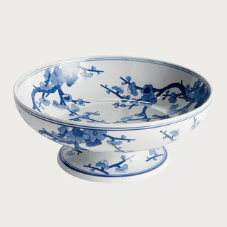 Blue and white Chinoiserie footed ceramic bowl featuring a classic botanical pattern on a crisp white base. A timeless spring decor accent ideal for dining tables, kitchen islands, consoles, shelves, and thoughtfully styled interiors.